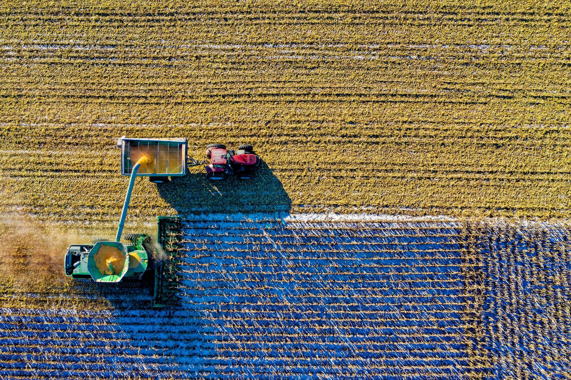 Aerial harvest with a combine unloading into a Case tractor cart