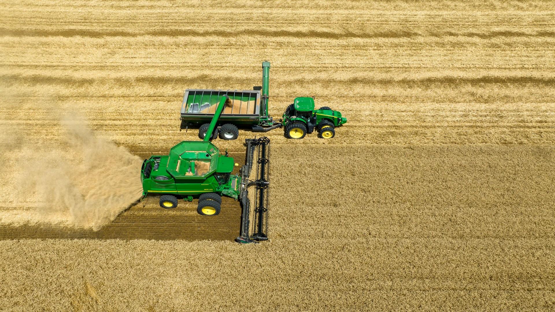 Aerial view of a combine and grain cart harvesting wheat