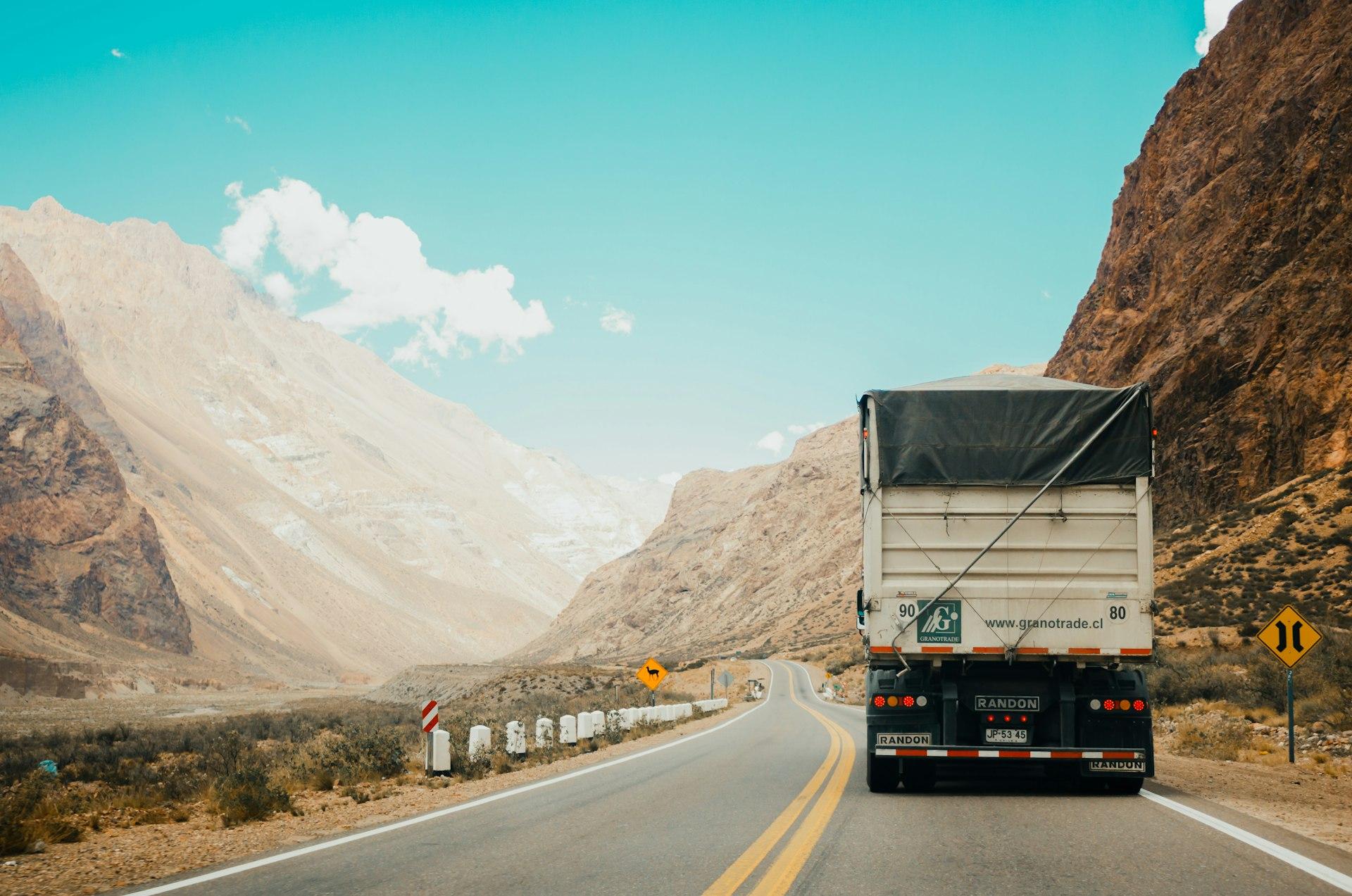 Grain trailer on a two-lane highway through open country